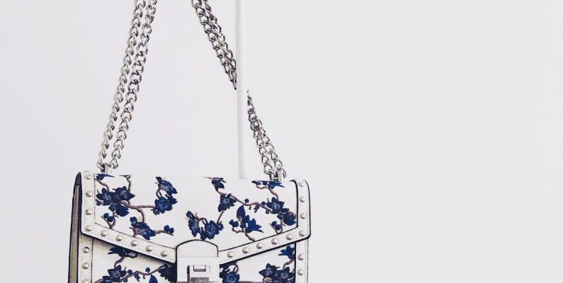 Handbags - White and Blue Floral Flap Sling Bag Hanging on White Steel Rack