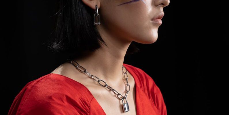 Jewelry - Woman with Face Paint Wearing a Silver Chain Necklace