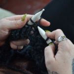 Woolen Products - Woman knitting with woolen threads at home
