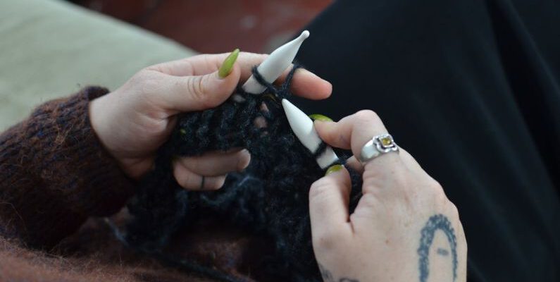 Woolen Products - Woman knitting with woolen threads at home