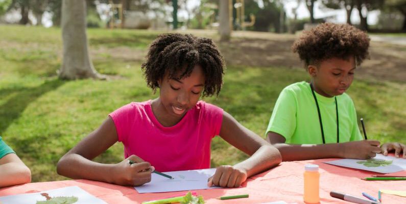 Eco-Friendly Crafts - A Young Girl and Boy Writing and Drawing on Papers at the Table