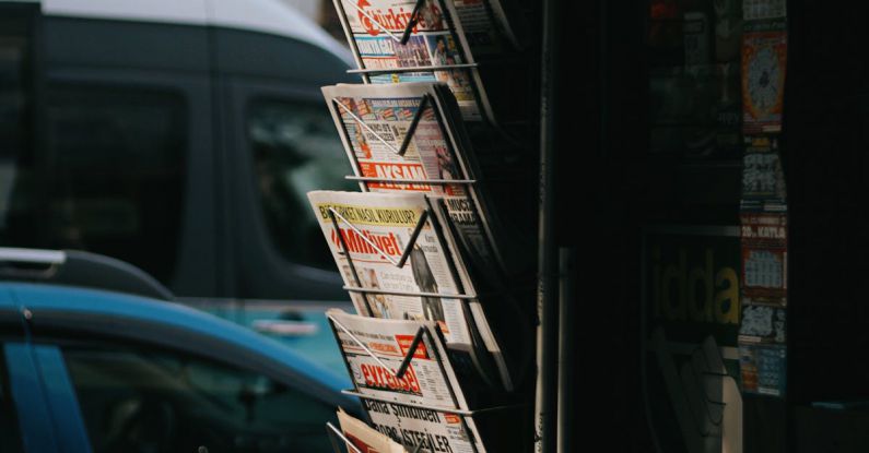 Shopping Hacks - A newspaper rack with a lot of newspapers on it