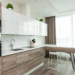 Large Appliances - Interior of modern light kitchen with white and wooden cabinets and contemporary appliances in apartment