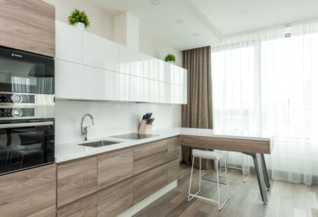 Large Appliances - Interior of modern light kitchen with white and wooden cabinets and contemporary appliances in apartment